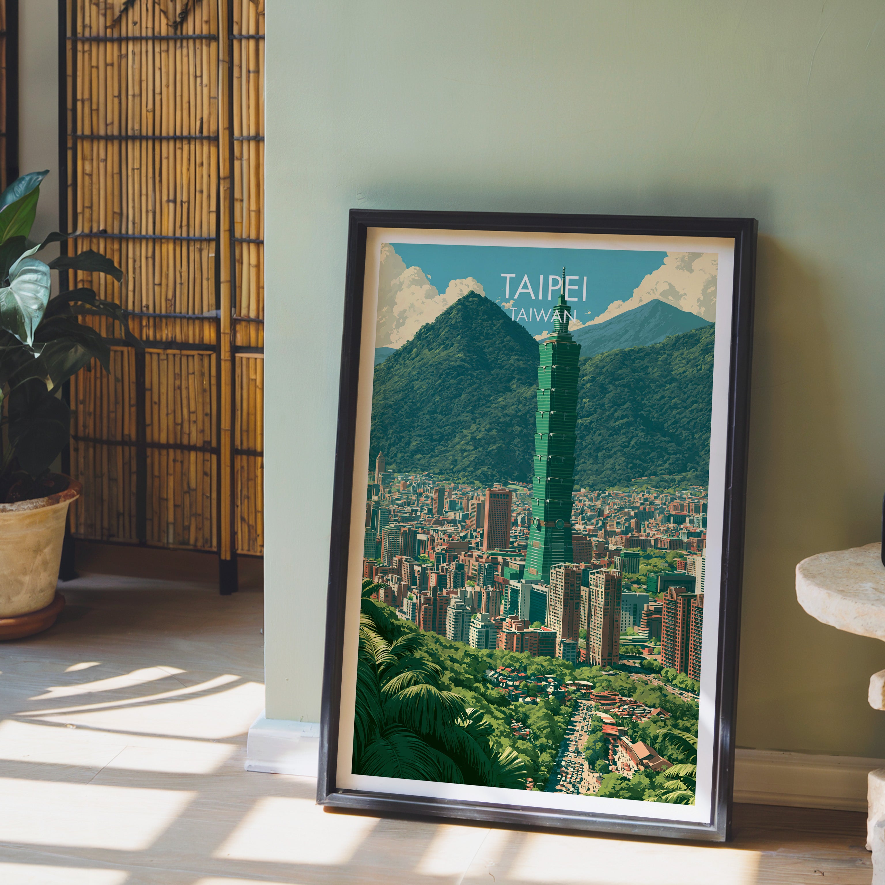 Taipei Taiwan wall art in a black frame leaning against a sage green wall beside a bamboo screen