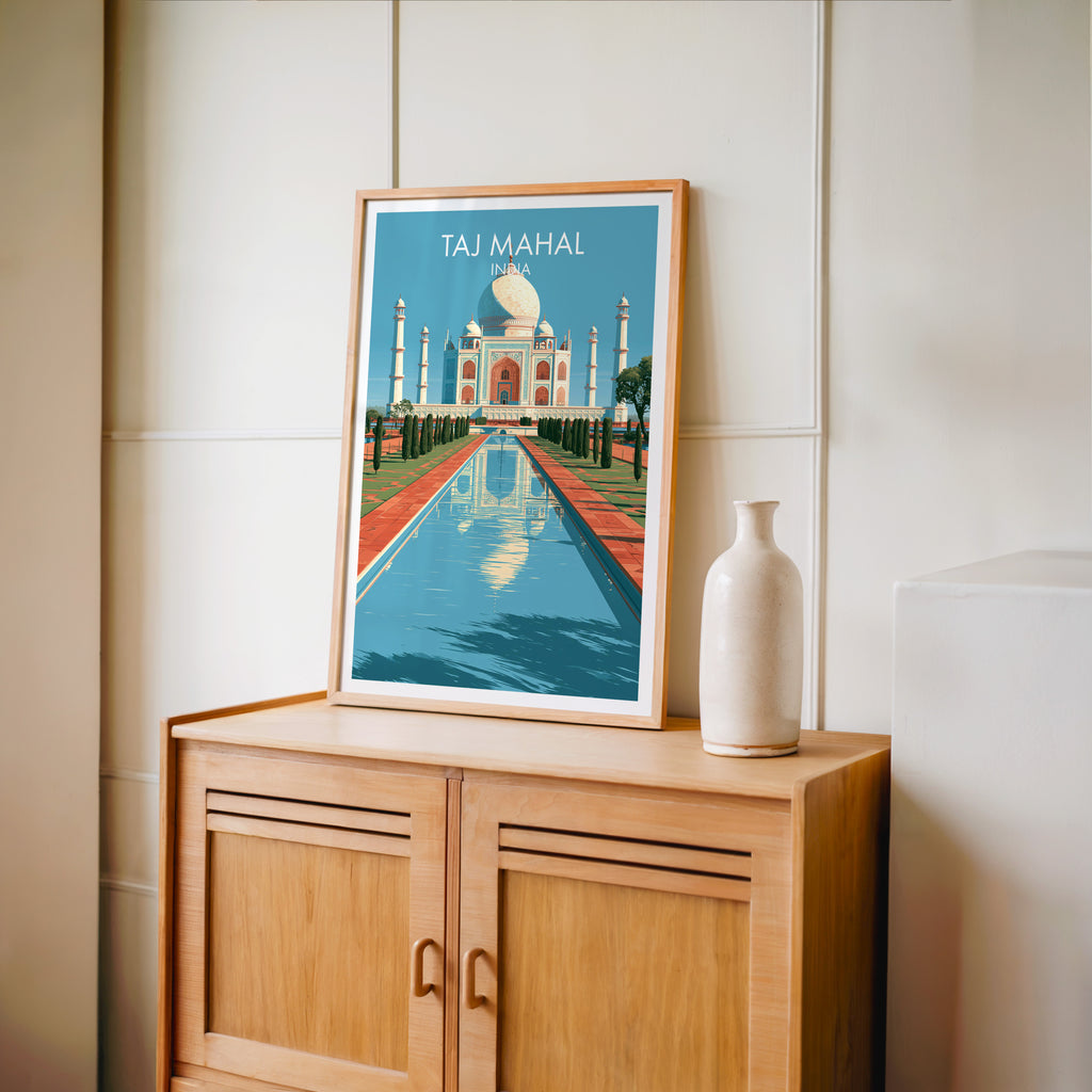 Small Taj Mahal Agra India travel poster in an oak frame on a mid-century sideboard with a ceramic vase