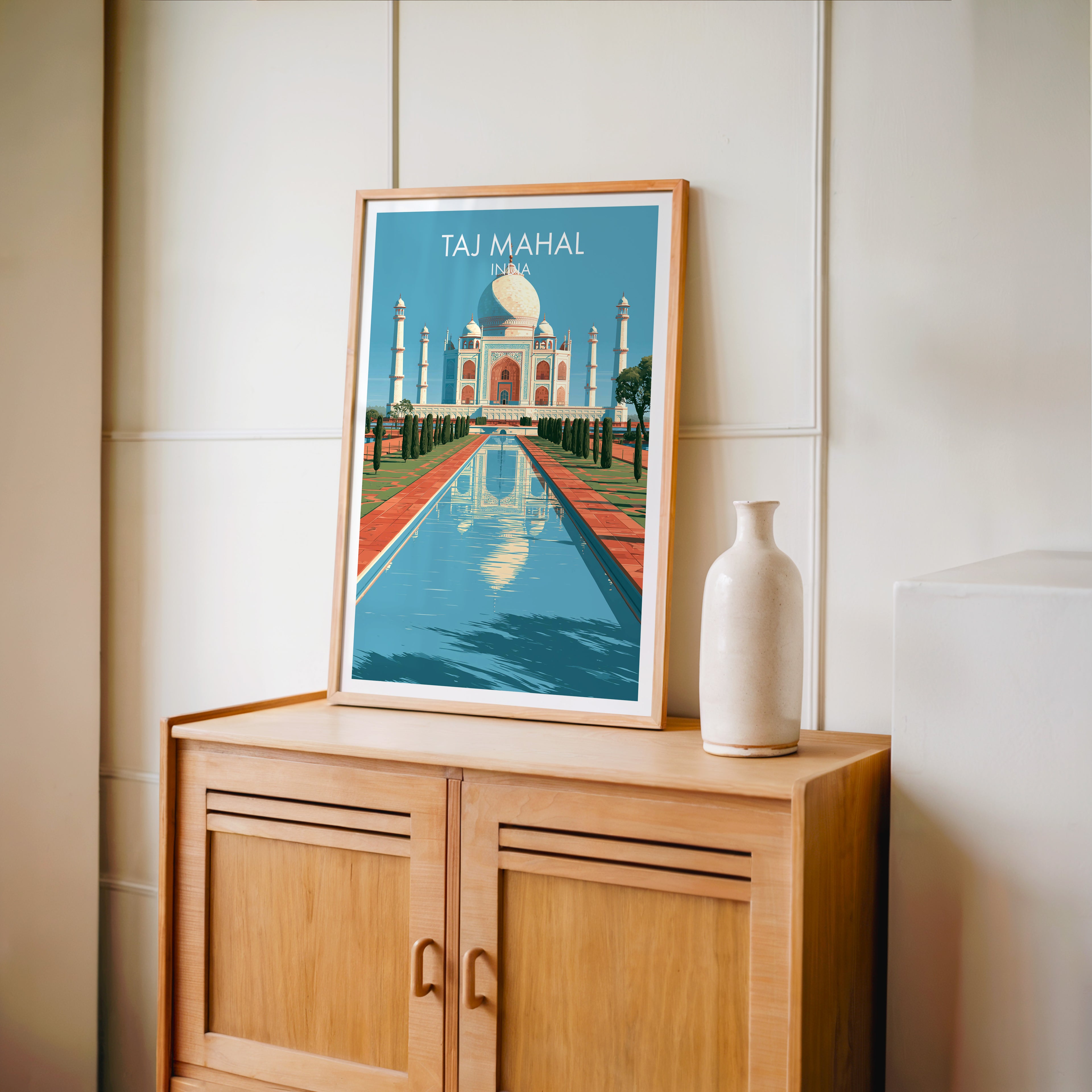 Small Taj Mahal Agra India travel poster in an oak frame on a mid-century sideboard with a ceramic vase