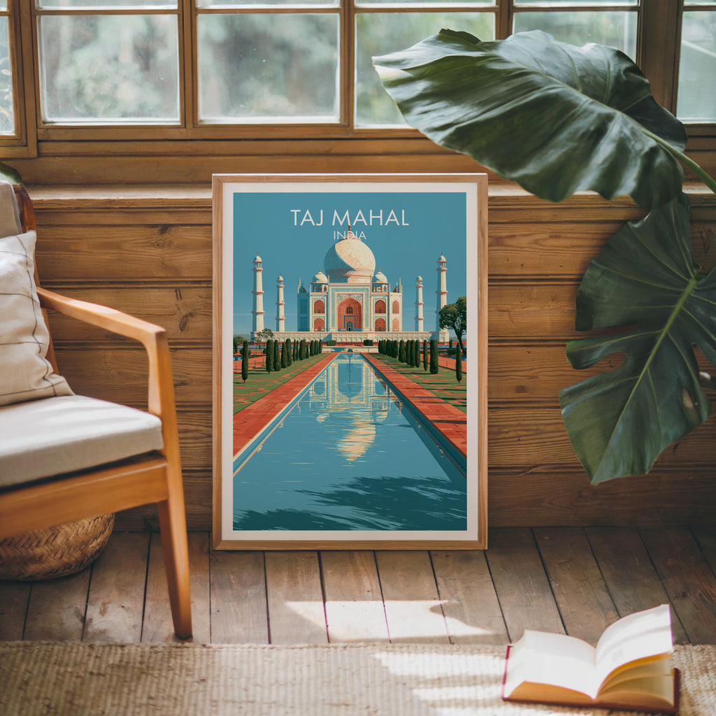 Framed Taj Mahal Agra India poster leaning against a timber cabin wall with monstera leaves and an open book