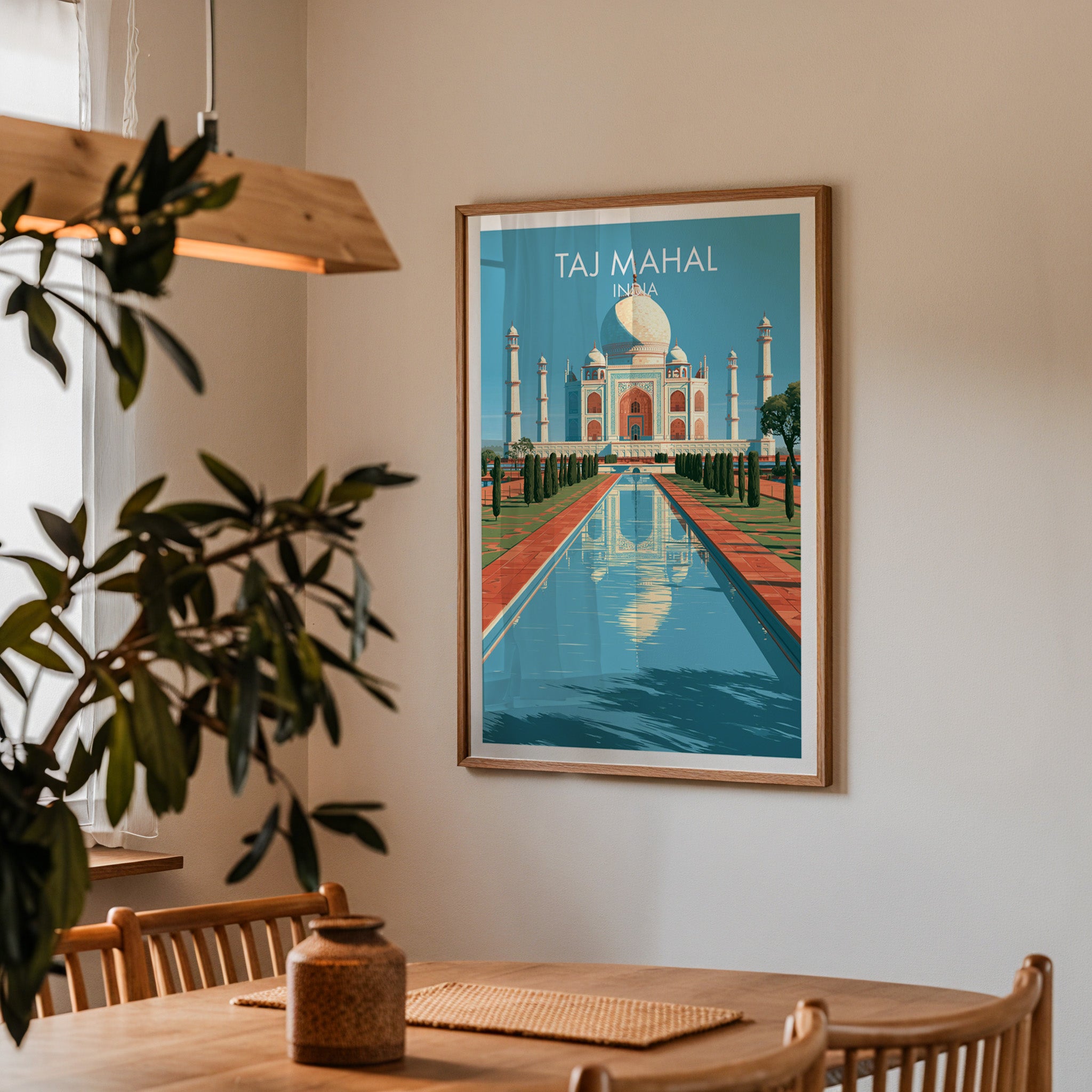 Framed Taj Mahal Agra India print on a dining room wall above an oak table in warm afternoon light