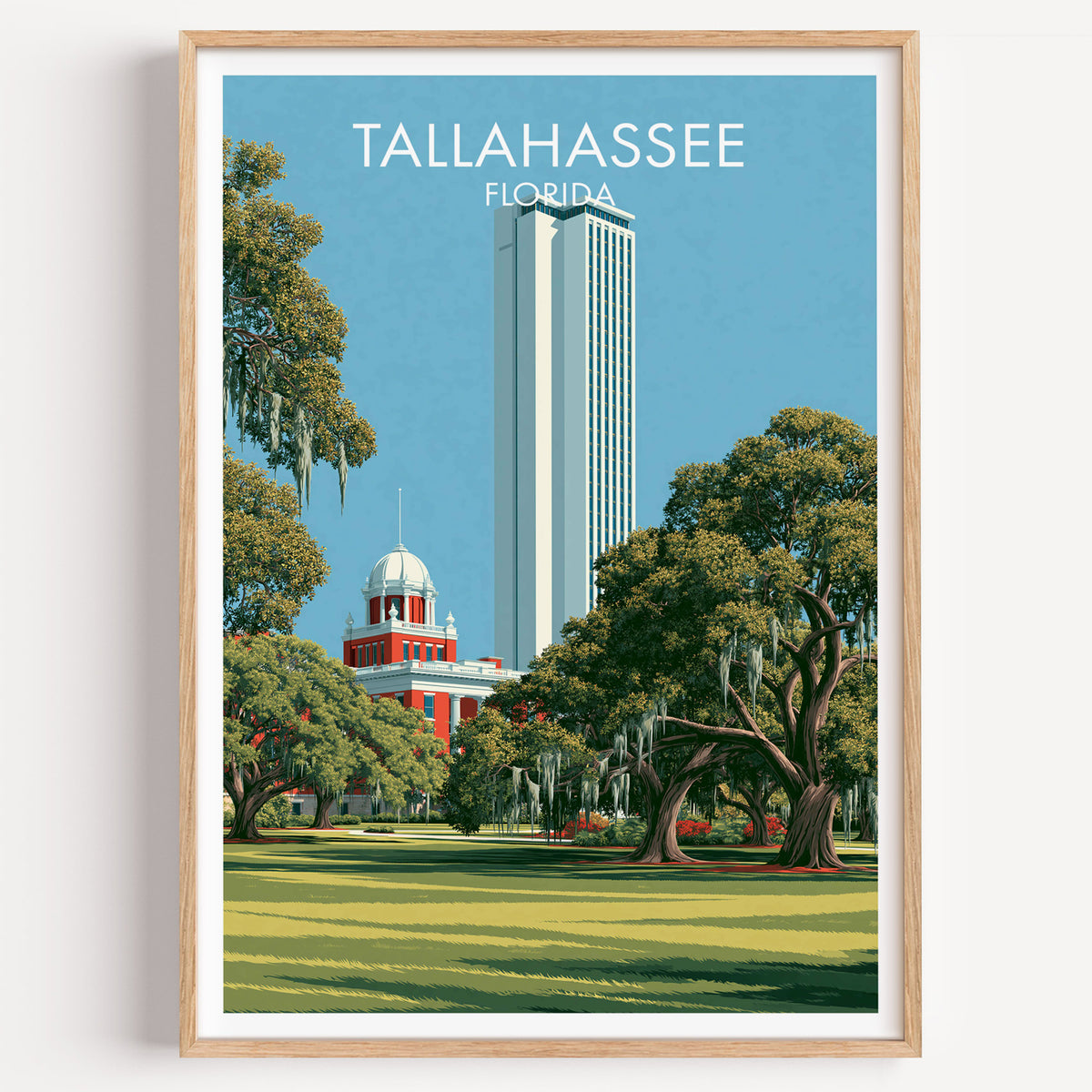 Tallahassee Florida live oaks and capitol travel poster in an oak frame on a plain white wall, front-lit.