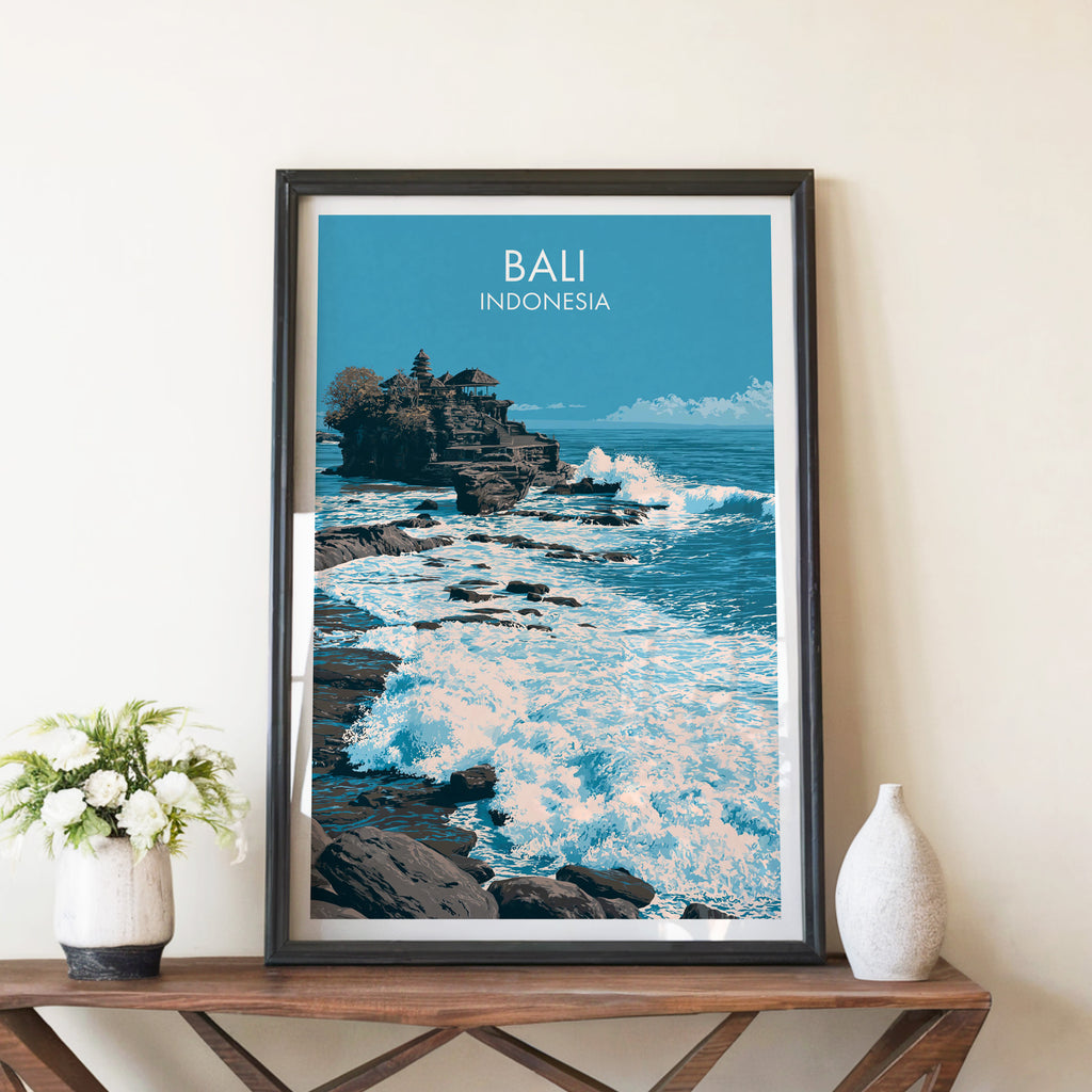 Tanah Lot Bali Indonesia travel poster in a black frame on a wooden console table with white flowers