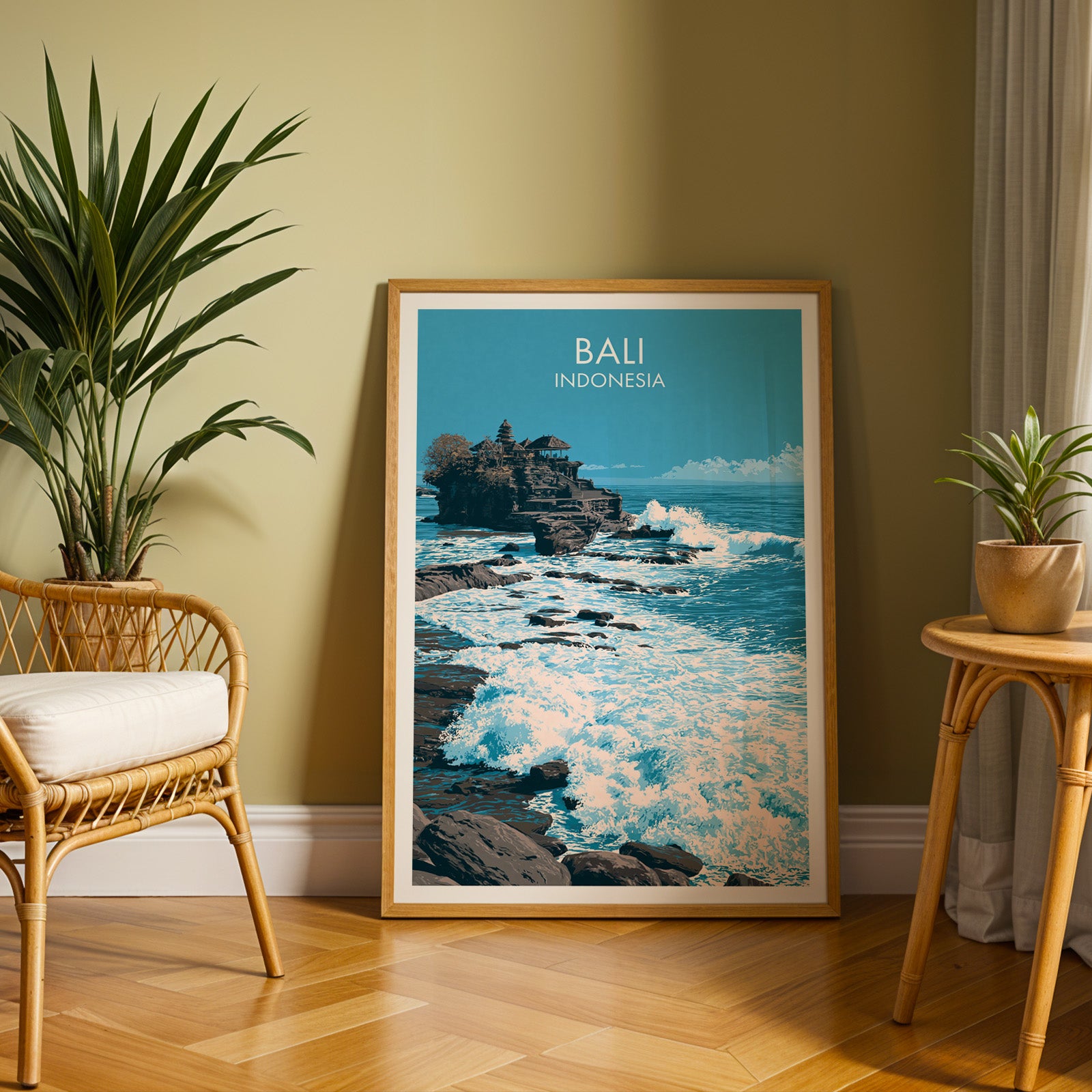 Large Tanah Lot Bali Indonesia travel print in an oak frame leaning on a herringbone floor next to a rattan chair