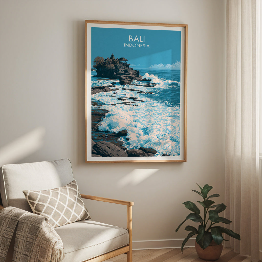 Tanah Lot Bali Indonesia travel print in a light oak frame on a living room wall beside a linen armchair