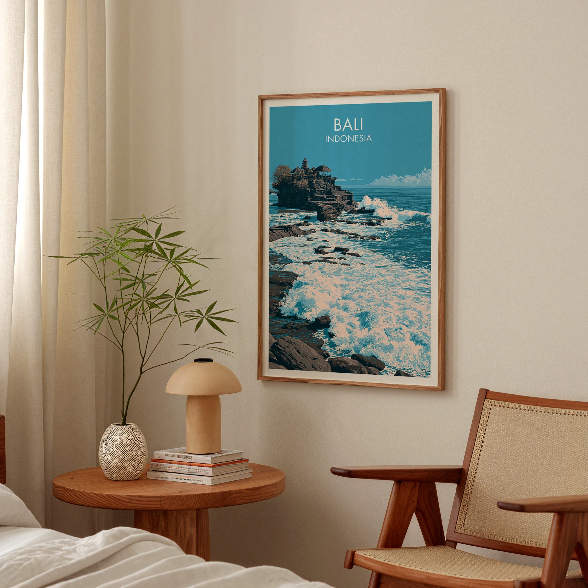 Tanah Lot Bali Indonesia poster above a bedroom nightstand with a bamboo plant and mushroom lamp