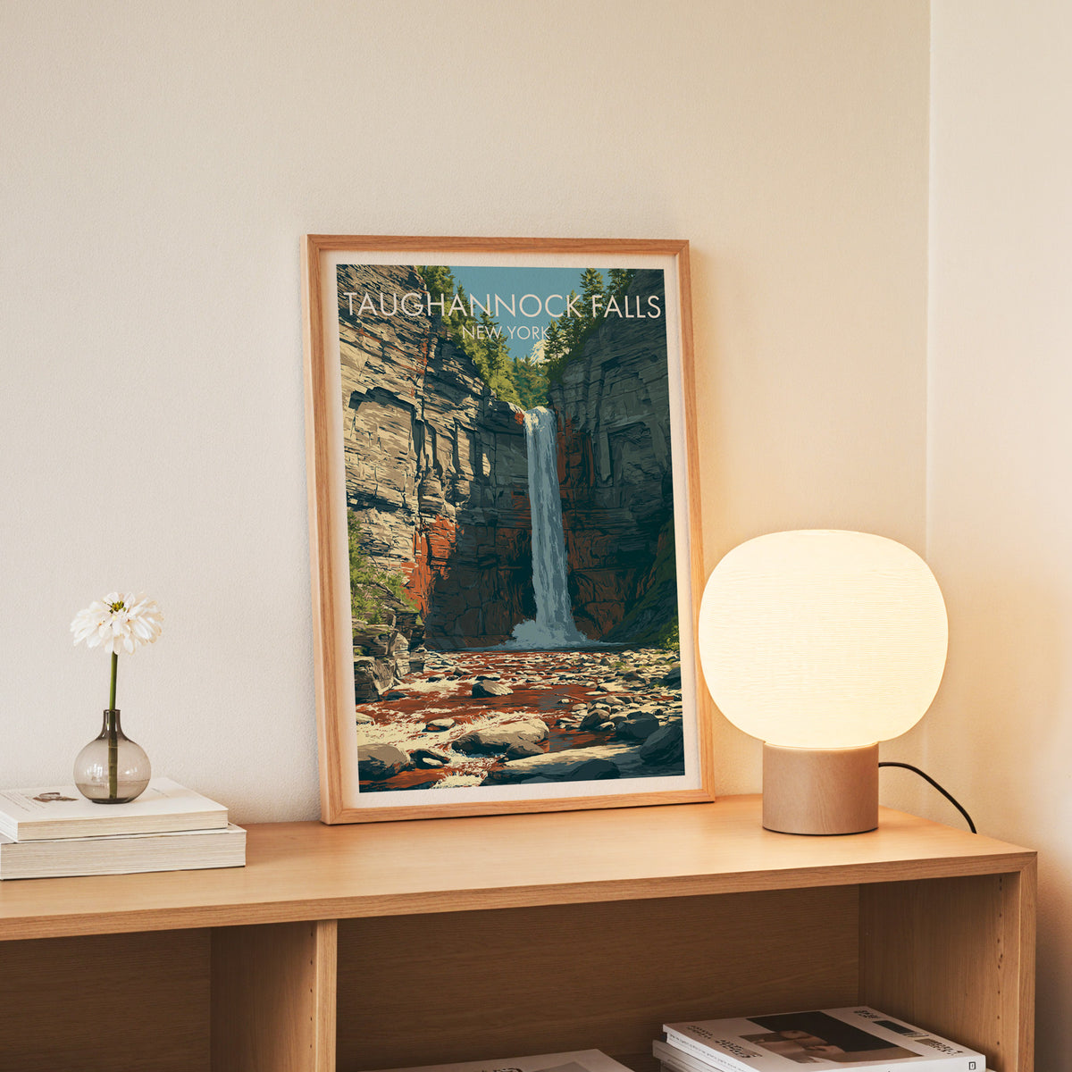 Slim oak frame on an oak console, Taughannock Falls New York art beside white daisies and books