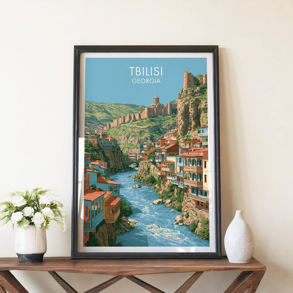 Tbilisi Georgia travel poster in a black frame on a wooden console table with white flowers