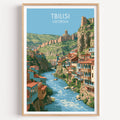 Tbilisi Georgia travel poster in a natural wood frame, shown against a clean white wall