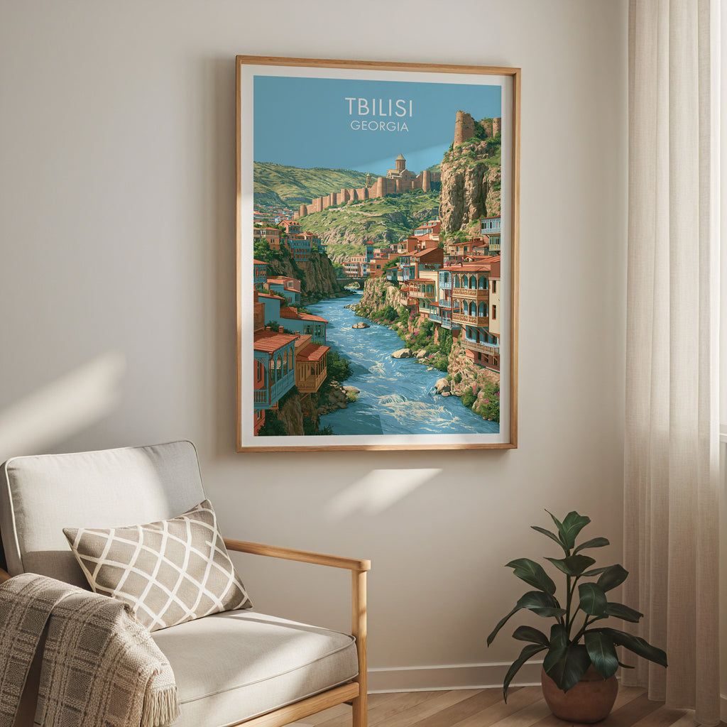 Tbilisi Georgia travel print in a light oak frame on a living room wall beside a linen armchair