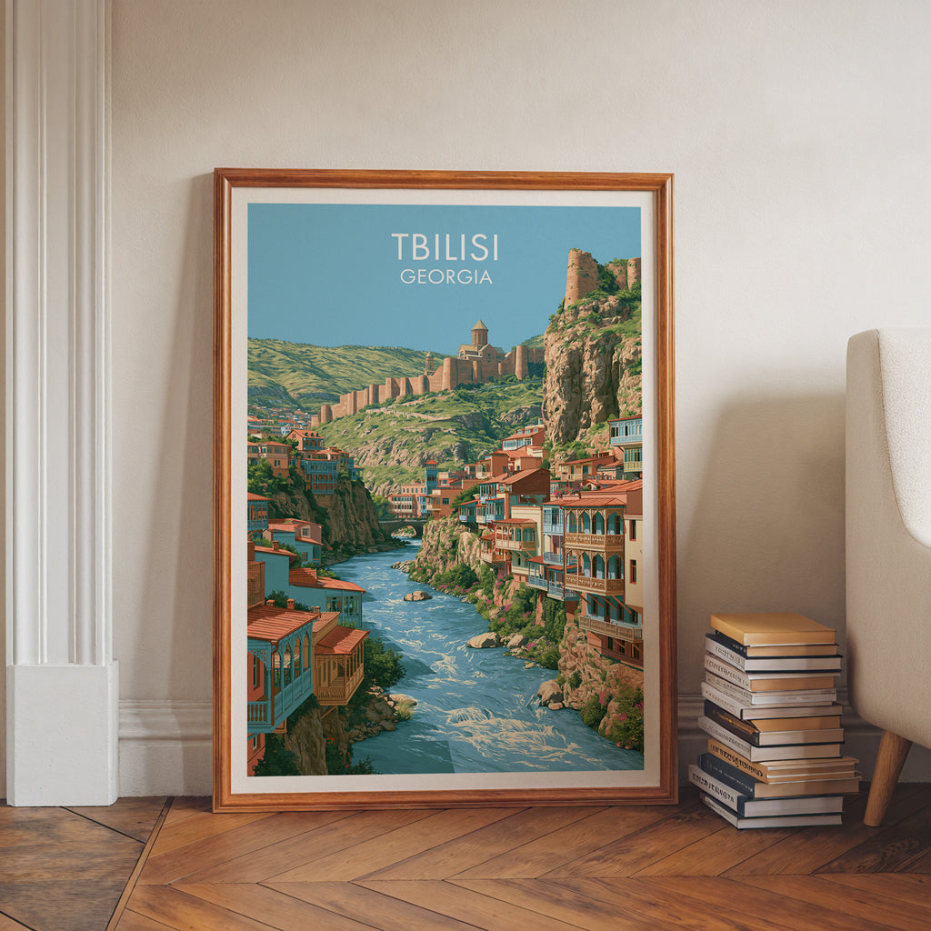 Tbilisi Georgia art print in a walnut frame leaning in a hallway beside stacked books