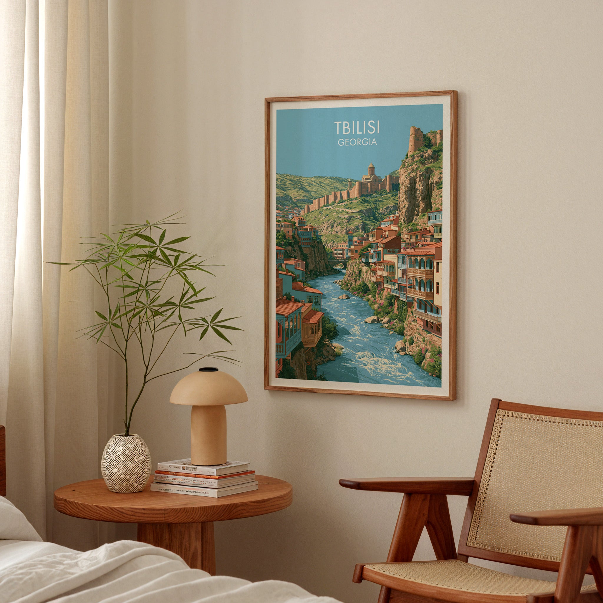Tbilisi Georgia poster above a bedroom nightstand with a bamboo plant and mushroom lamp