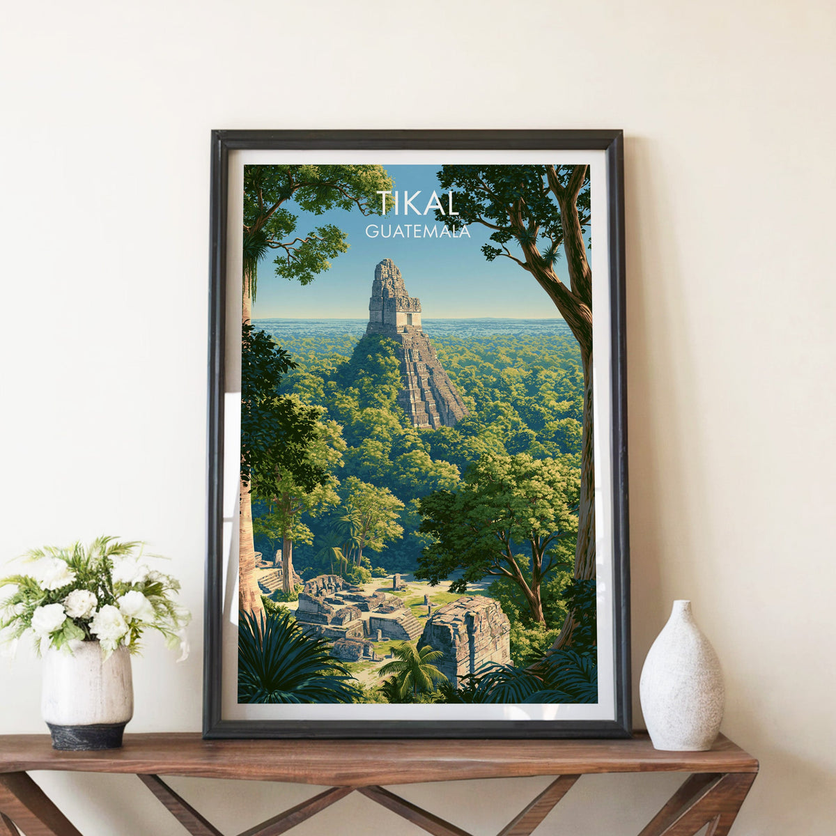 Stepped pyramid over rainforest, black frame on a walnut console with white peonies and a ceramic vase