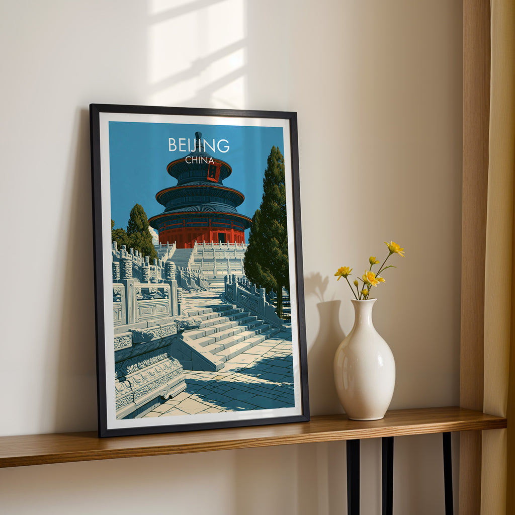 Black framed Temple of Heaven Beijing print on a narrow hallway console in sunlight, styled with yellow flowers