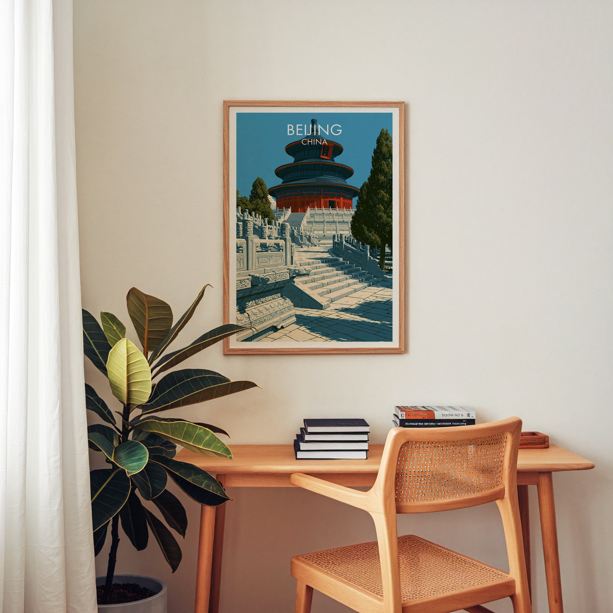 Temple of Heaven Beijing wall art above a wooden home office desk with a rattan chair and books