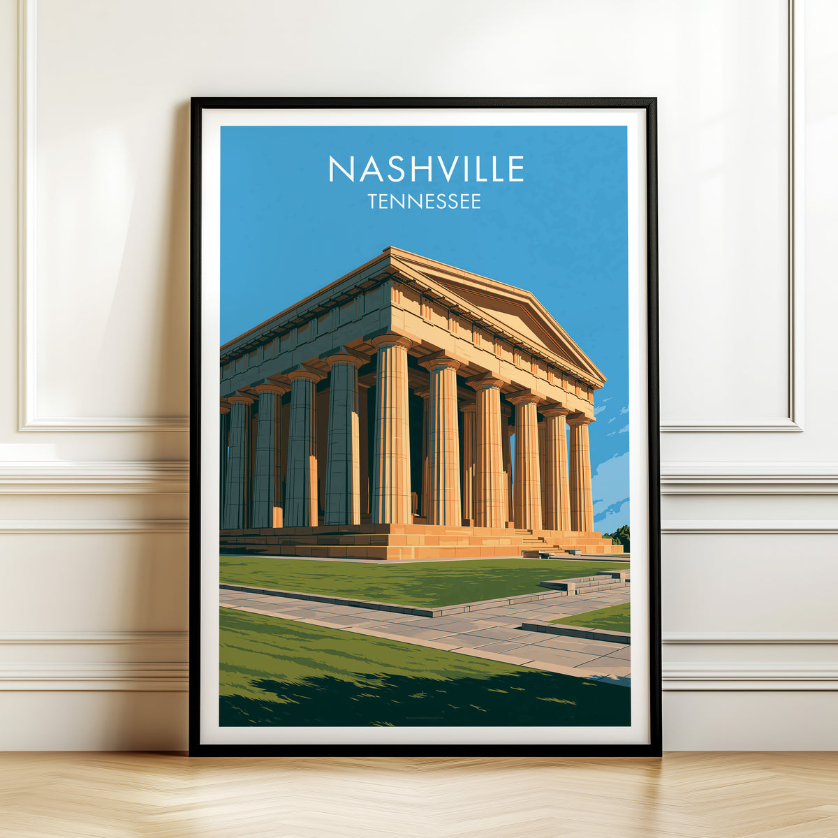 Nashville Parthenon canvas print in a black frame by a moulded white wall above a herringbone wood floor.