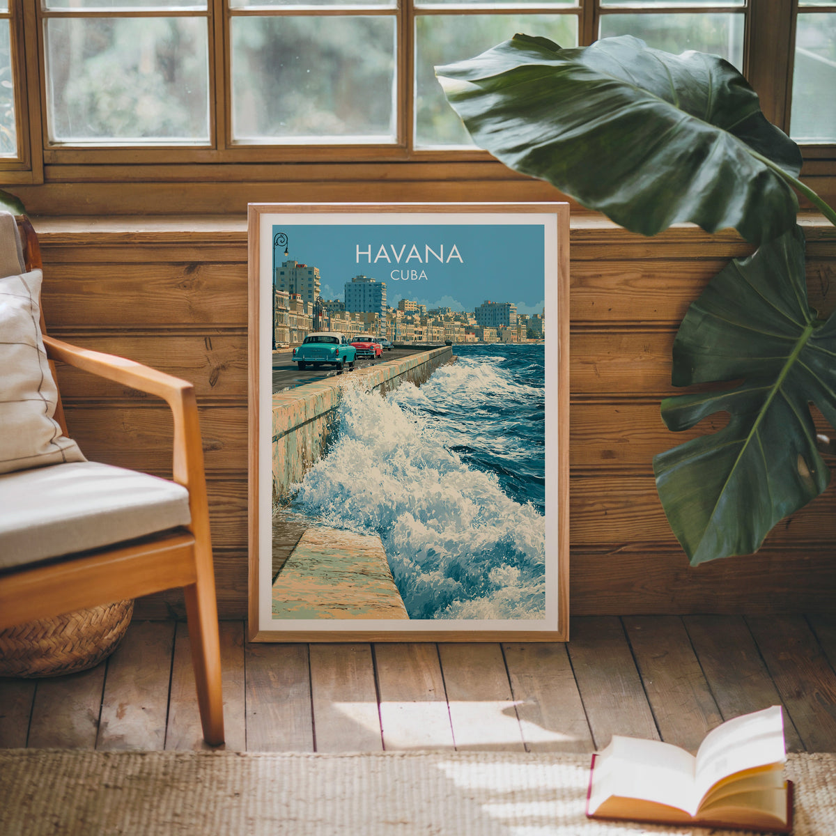 Cuban coastal art in an oak frame leaning on a pine cabin wall with a wooden armchair, monstera leaf and jute rug