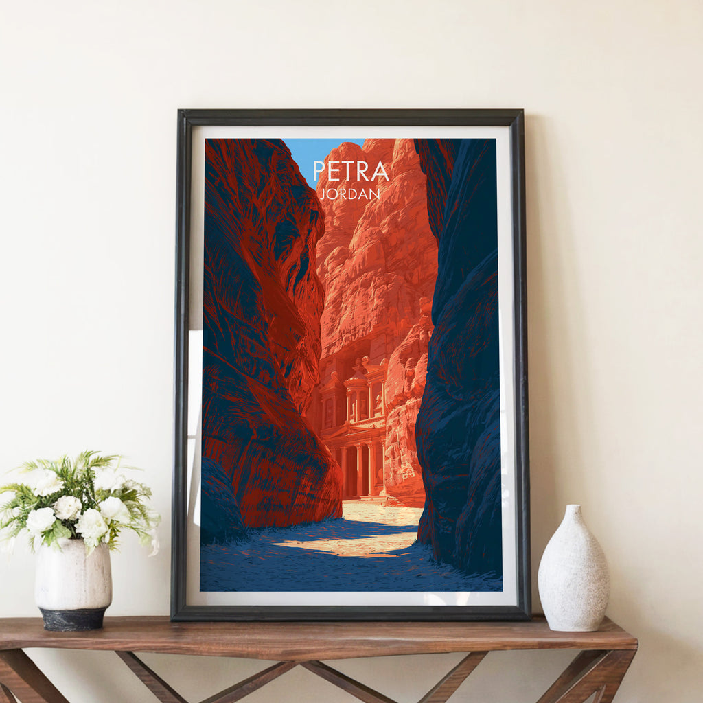 Petra Jordan Treasury travel poster in a black frame on a wooden console table with white flowers