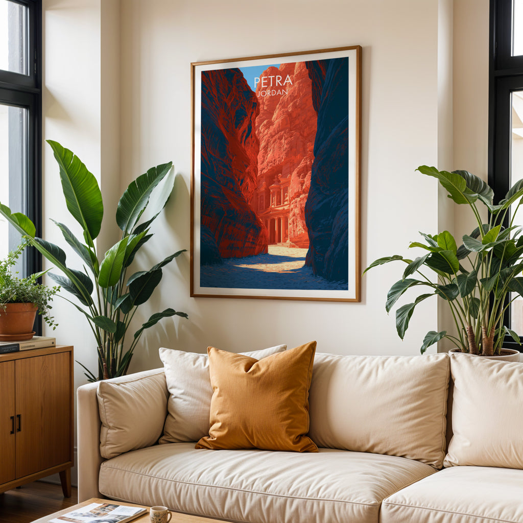 Framed Petra Jordan Treasury wall art hanging above a cream sofa in a bright living room with tropical plants