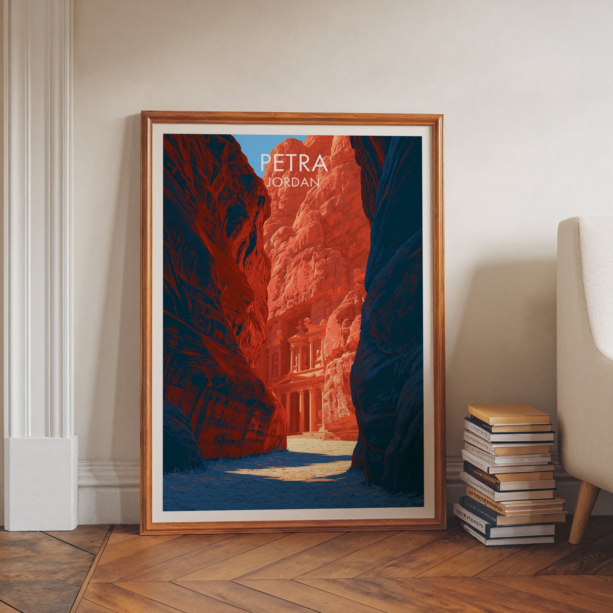 Petra Jordan Treasury art print in a walnut frame leaning in a hallway beside stacked books