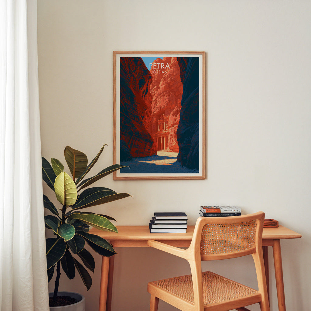 Petra Jordan Treasury wall art above a wooden home office desk with a rattan chair and books