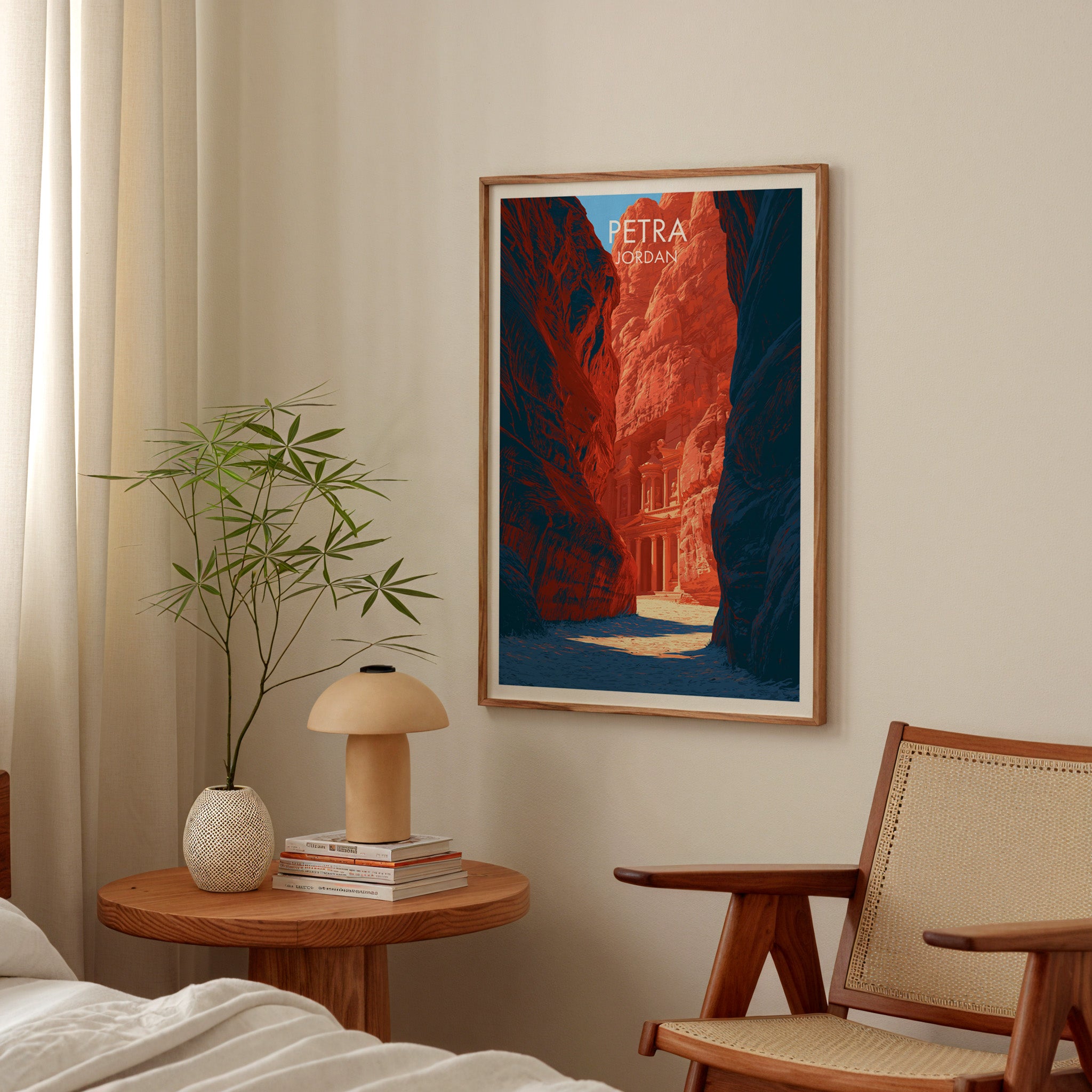 Petra Jordan Treasury poster above a bedroom nightstand with a bamboo plant and mushroom lamp