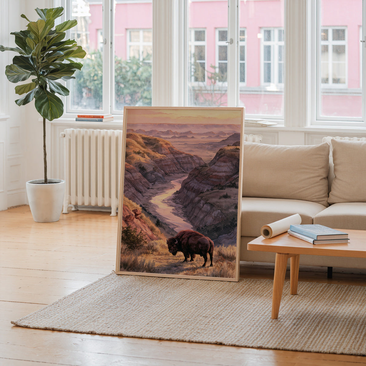 Theodore Roosevelt watercolor art print leaning against a living room wall beside a linen sofa and coffee table