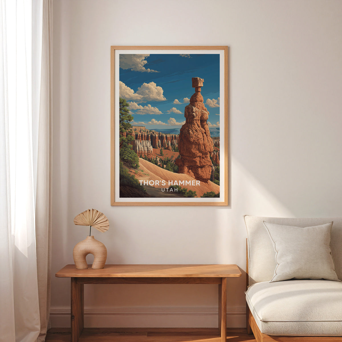 Bryce Canyon rock spire print in oak above a slim wood bench with a cream armchair