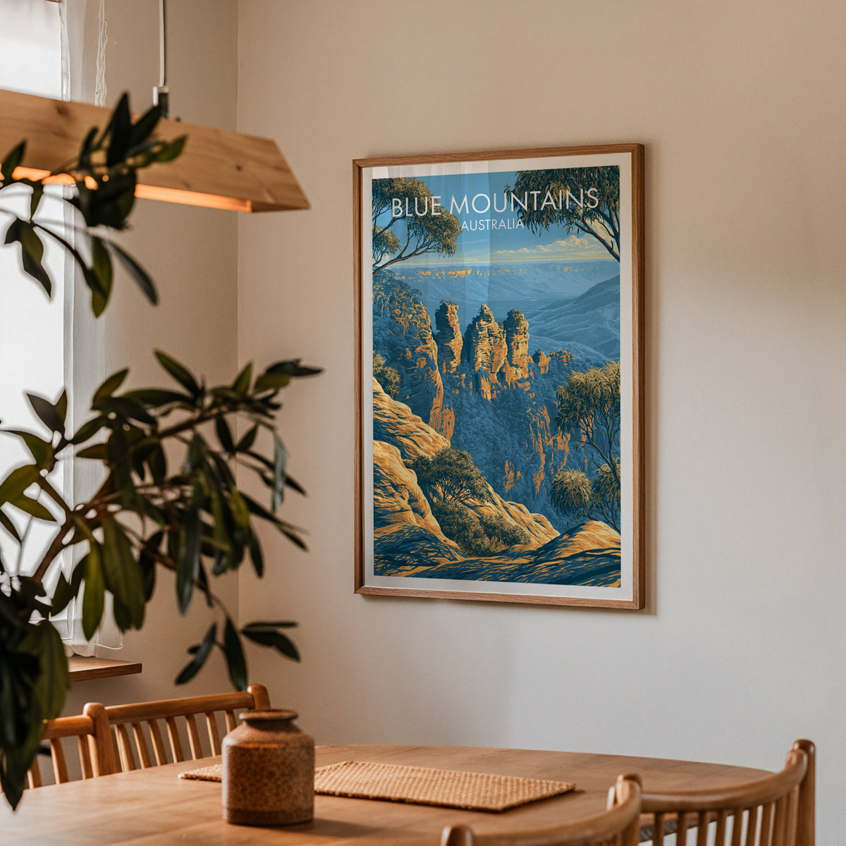 Framed Blue Mountains print in a dining corner with an oak table, spindle chairs and pendant light