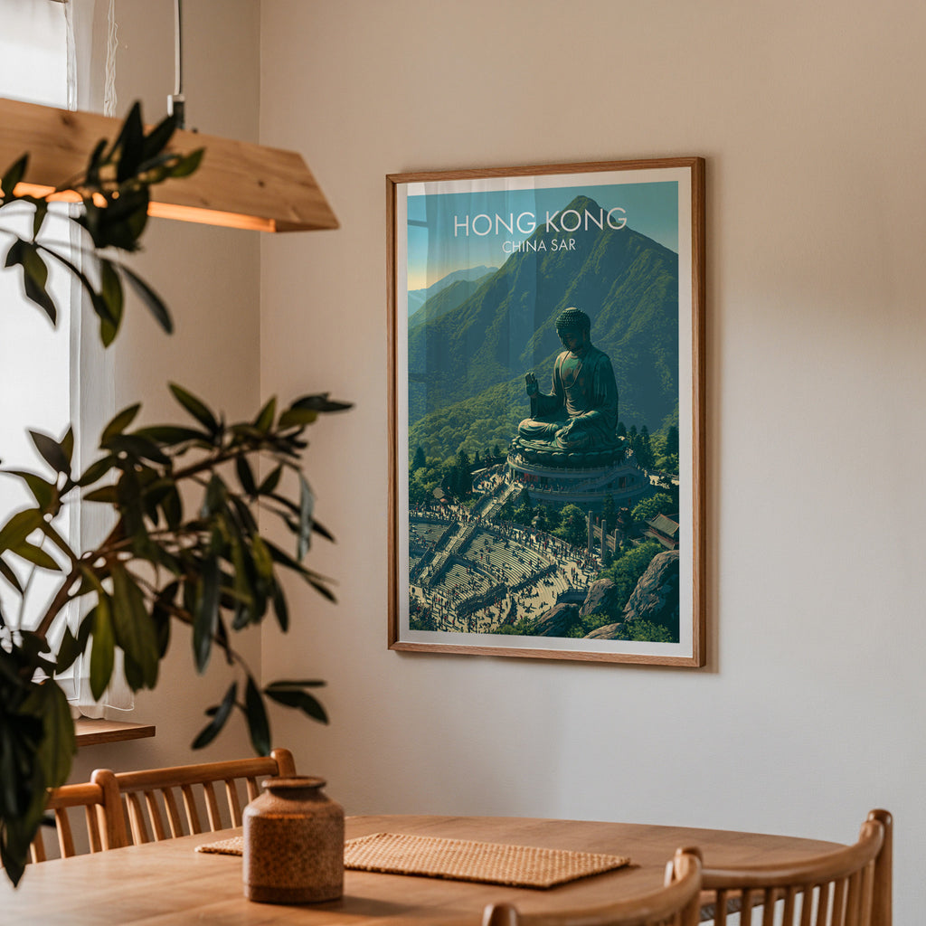 Framed Tian Tan Big Buddha Hong Kong print on a dining room wall above an oak table in warm afternoon light