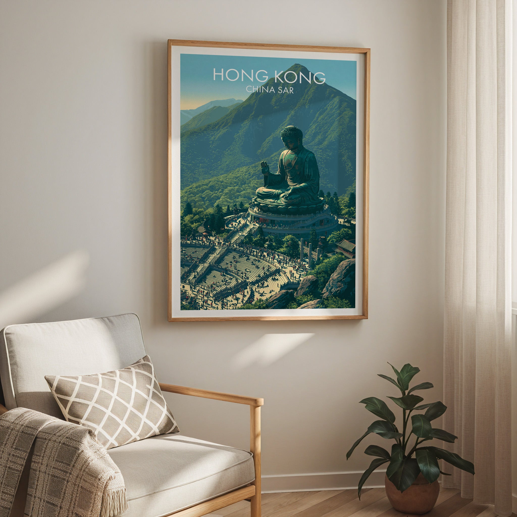 Tian Tan Big Buddha Hong Kong travel print in a light oak frame on a living room wall beside a linen armchair