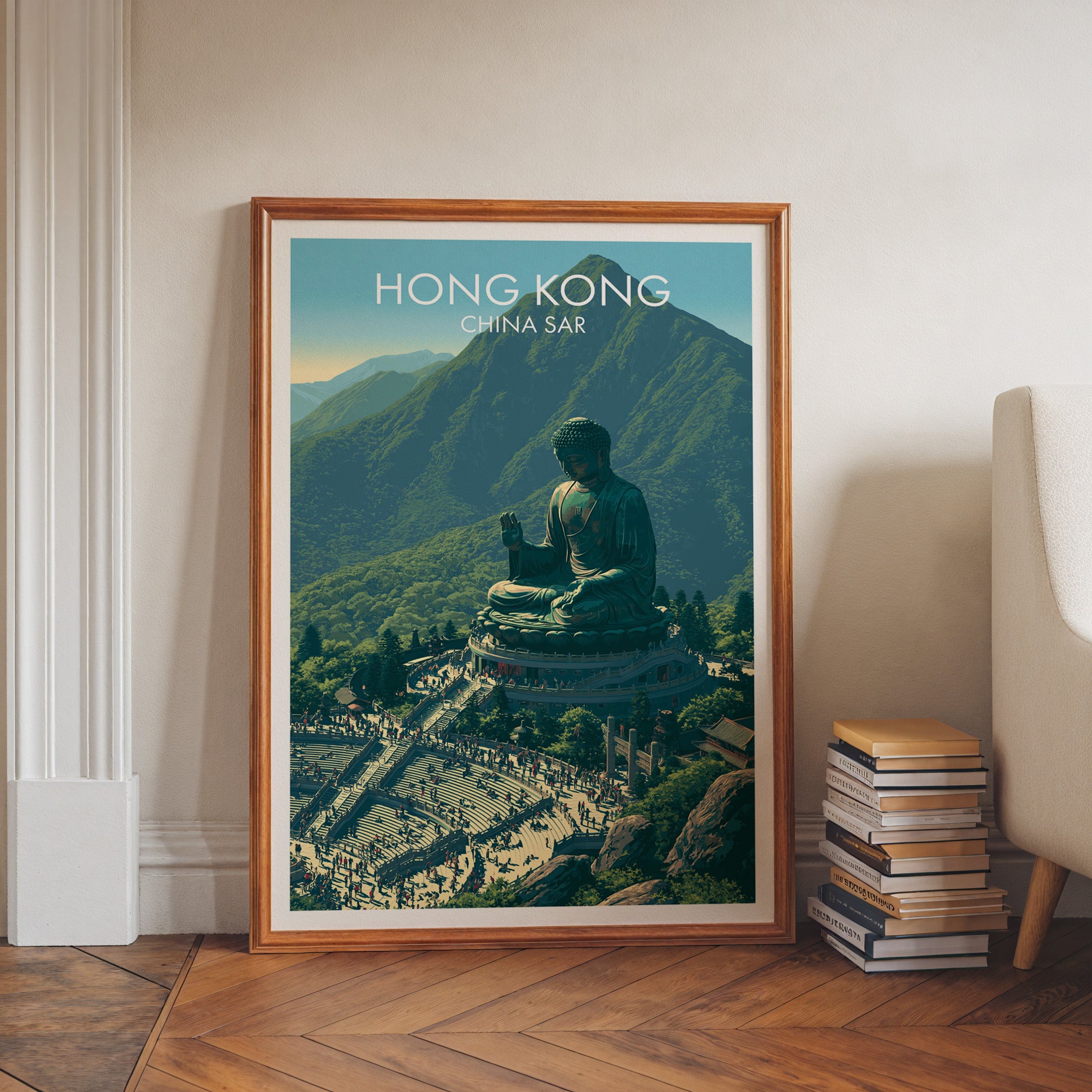 Tian Tan Big Buddha Hong Kong art print in a walnut frame leaning in a hallway beside stacked books