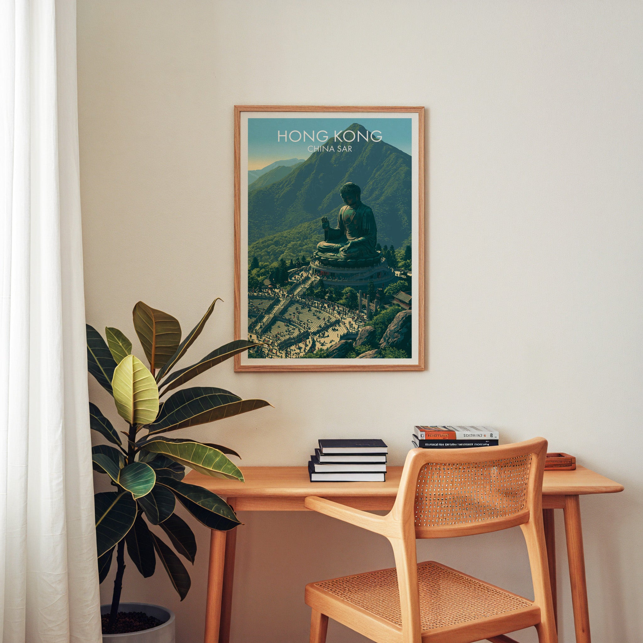 Tian Tan Big Buddha Hong Kong wall art above a wooden home office desk with a rattan chair and books