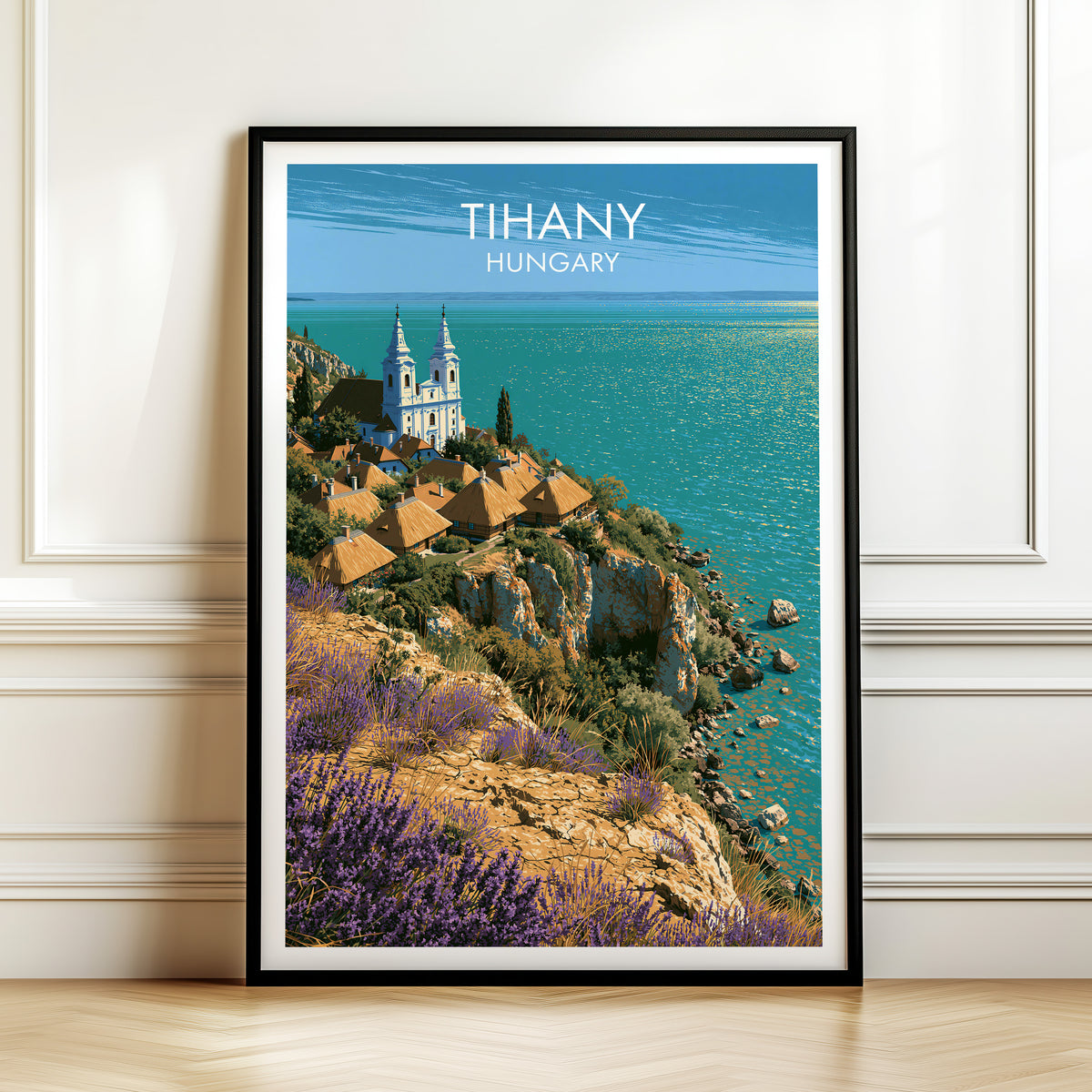 Tihany abbey lavender print, black frame leaning on a white panelled wall above a herringbone floor