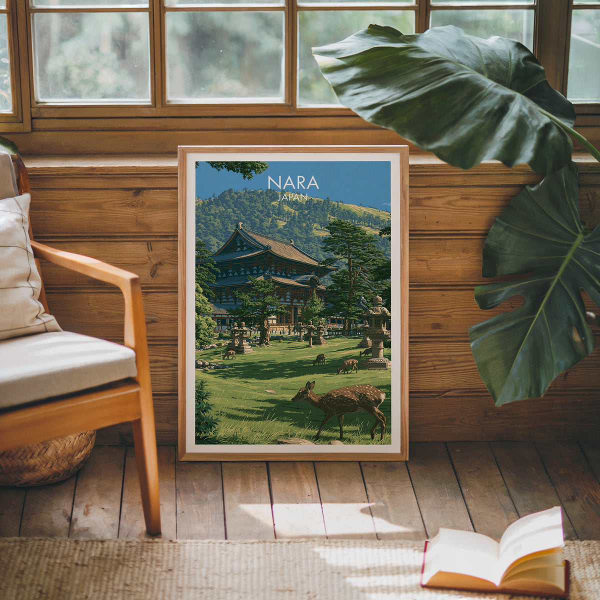 Todai-ji Nara temple print in an oak frame leaning on a pine cabin wall with a monstera leaf and open book