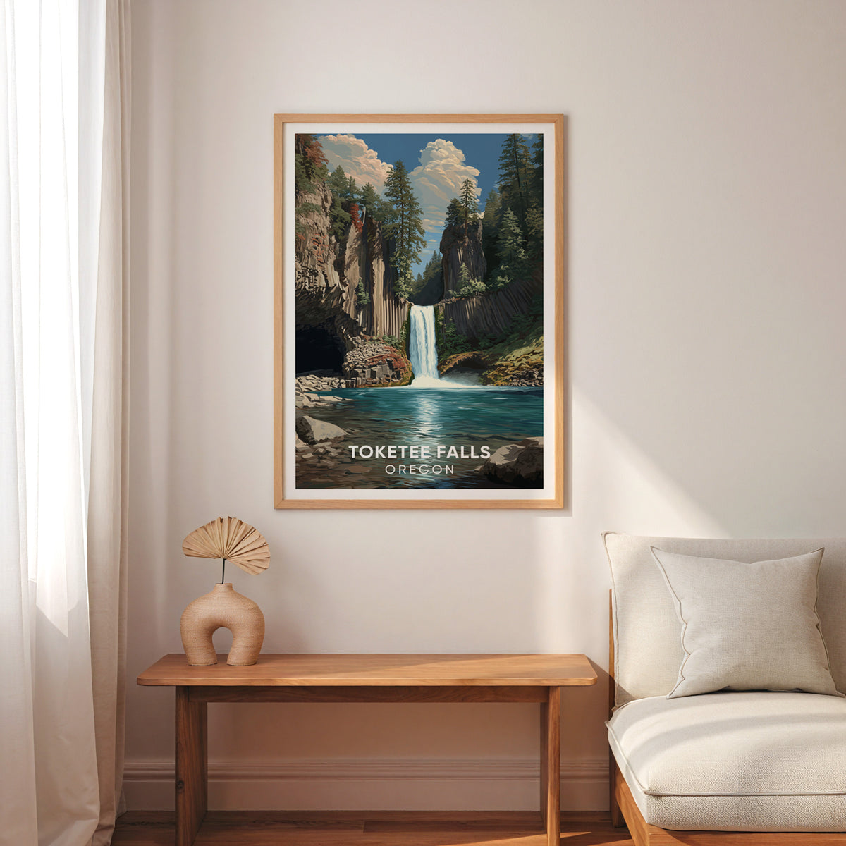 Toketee Falls artwork in oak above a slim wood bench, cream armchair, sheer curtains and a handled vase.