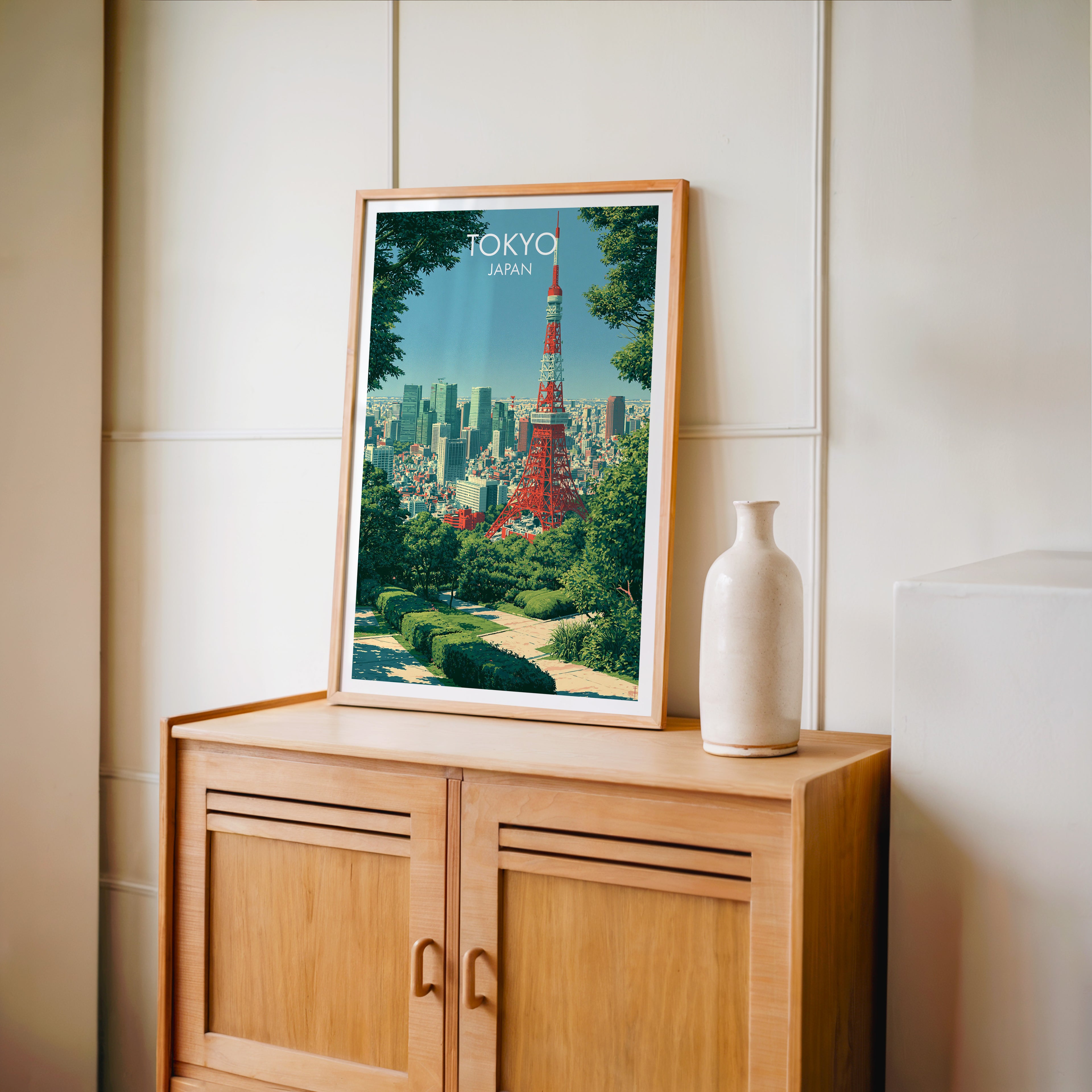 Small Tokyo Tower Japan travel poster in an oak frame on a mid-century sideboard with a ceramic vase