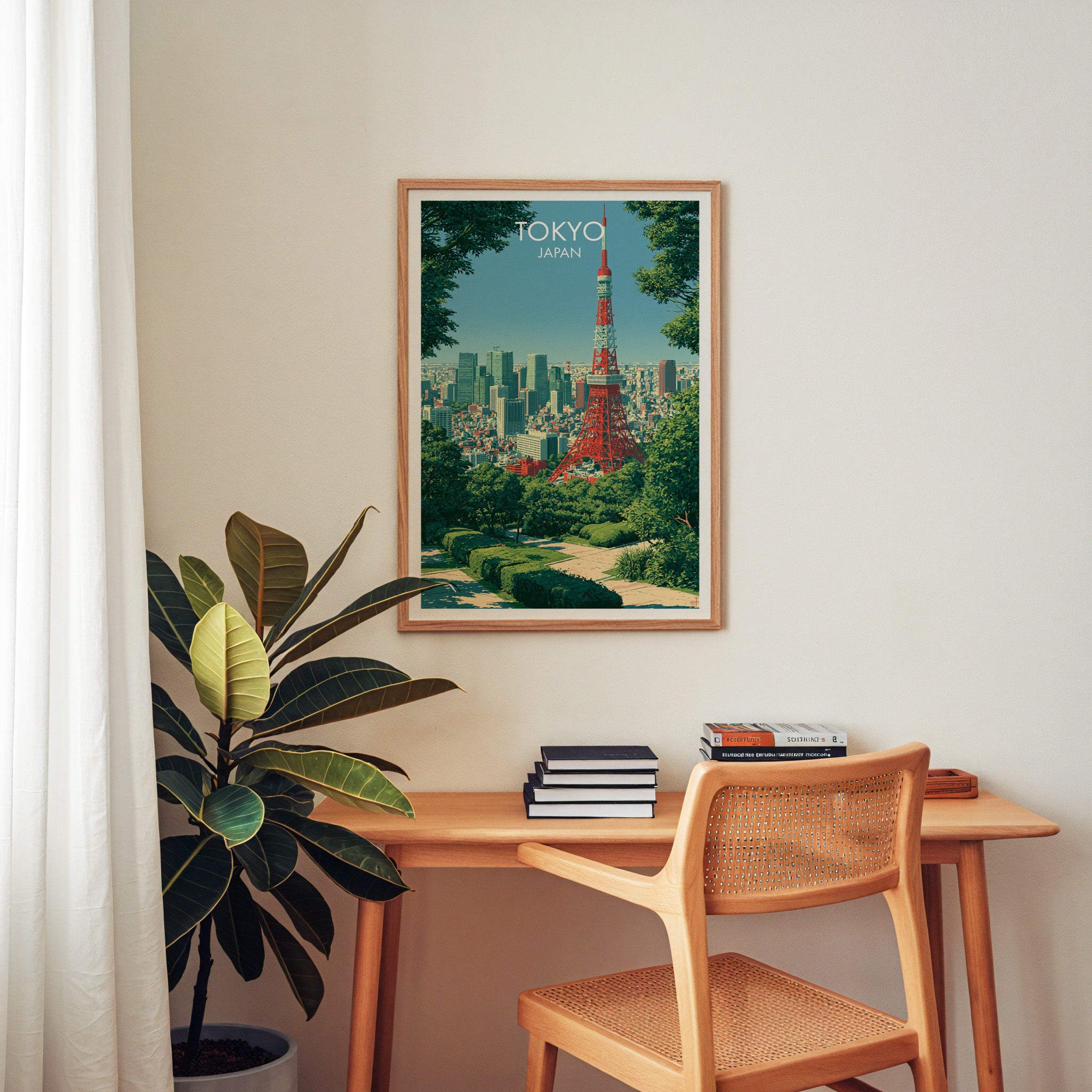 Tokyo Tower Japan wall art above a wooden home office desk with a rattan chair and books