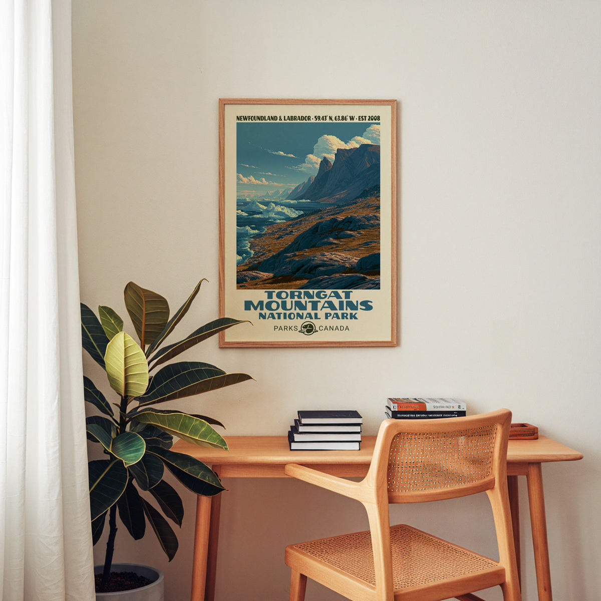 Torngat Canada vintage poster in an oak frame above a wood desk with a cane chair
