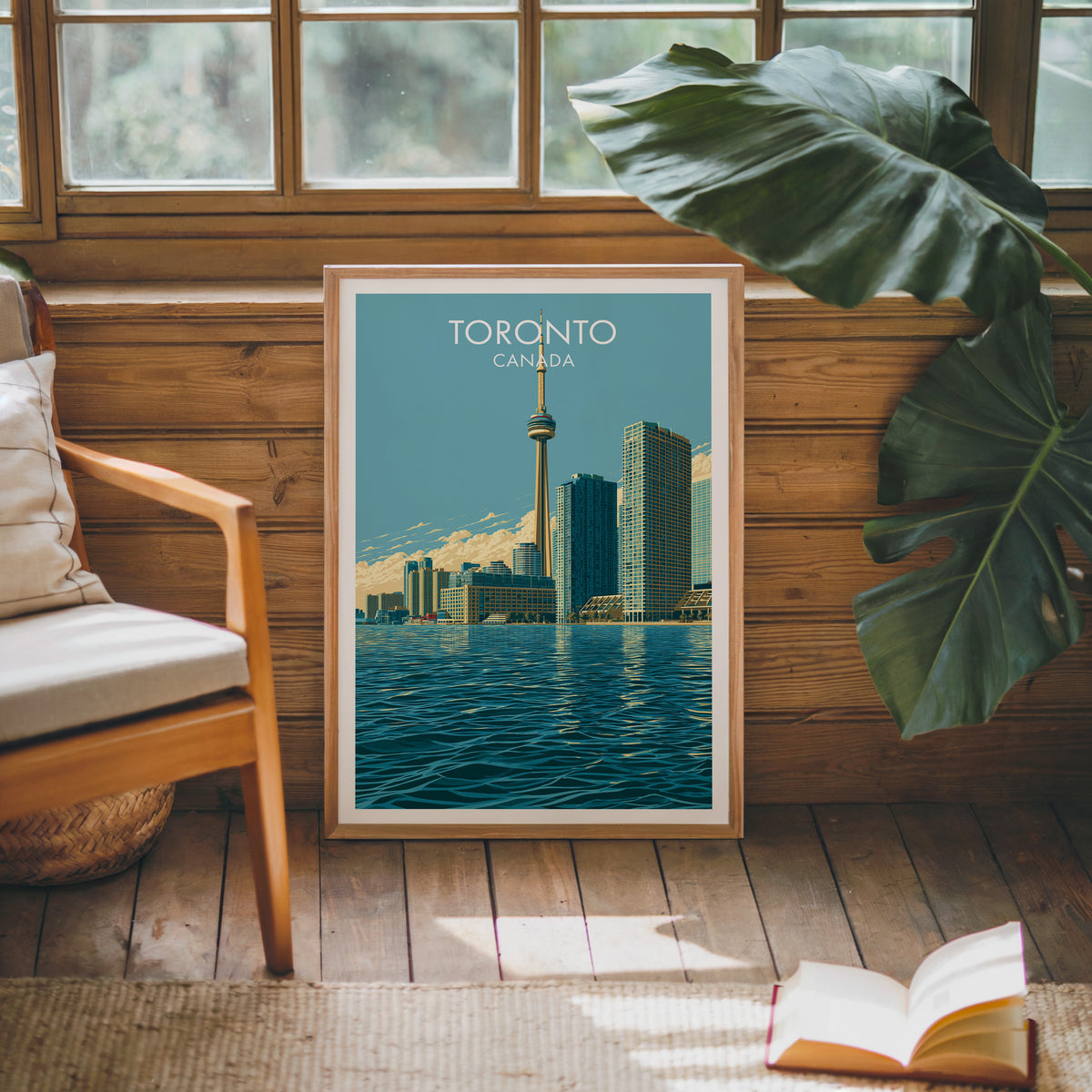 Toronto Ontario skyline wall art in an oak frame against a pine cabin wall beside a monstera