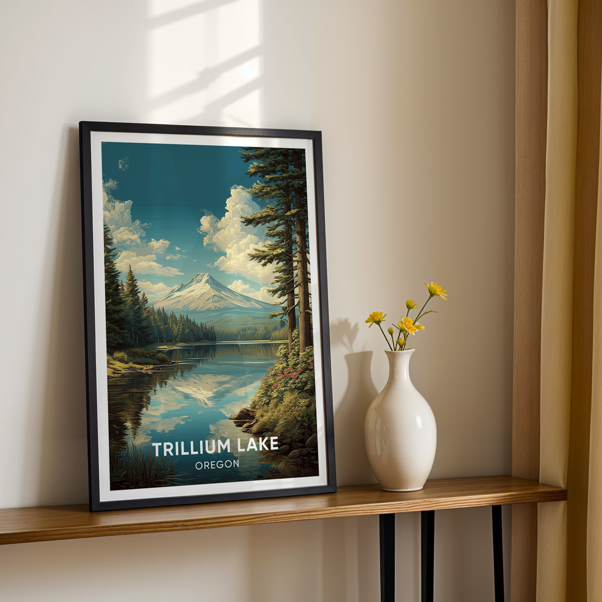 Oregon lake print in a black frame on a narrow wood console beside a white vase of yellow blooms.