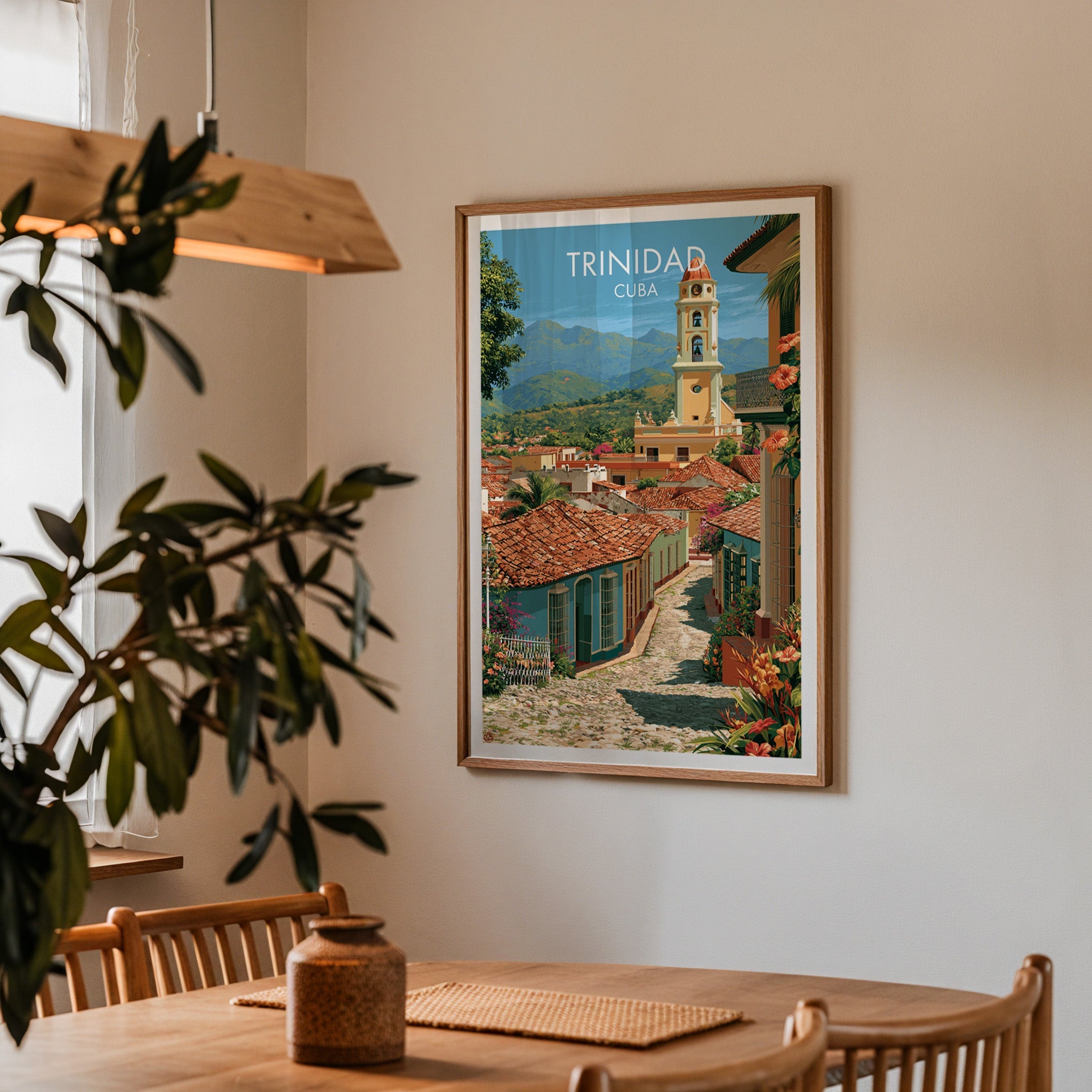 Trinidad bell tower art in an oak frame in a dining corner with an oak table, spindle chairs and pendant lamp