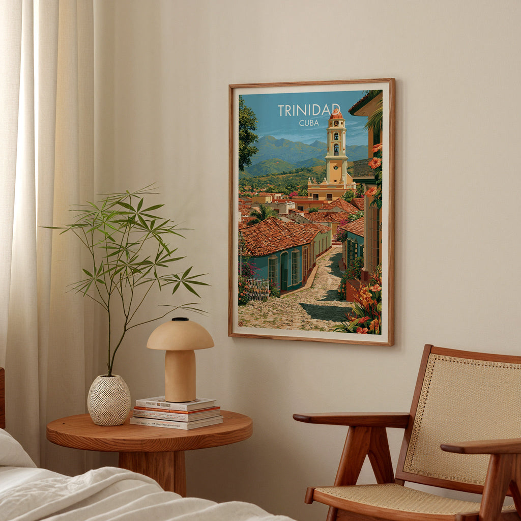 Terracotta and teal Trinidad print in an oak frame in a bedroom above a round table with a mushroom lamp
