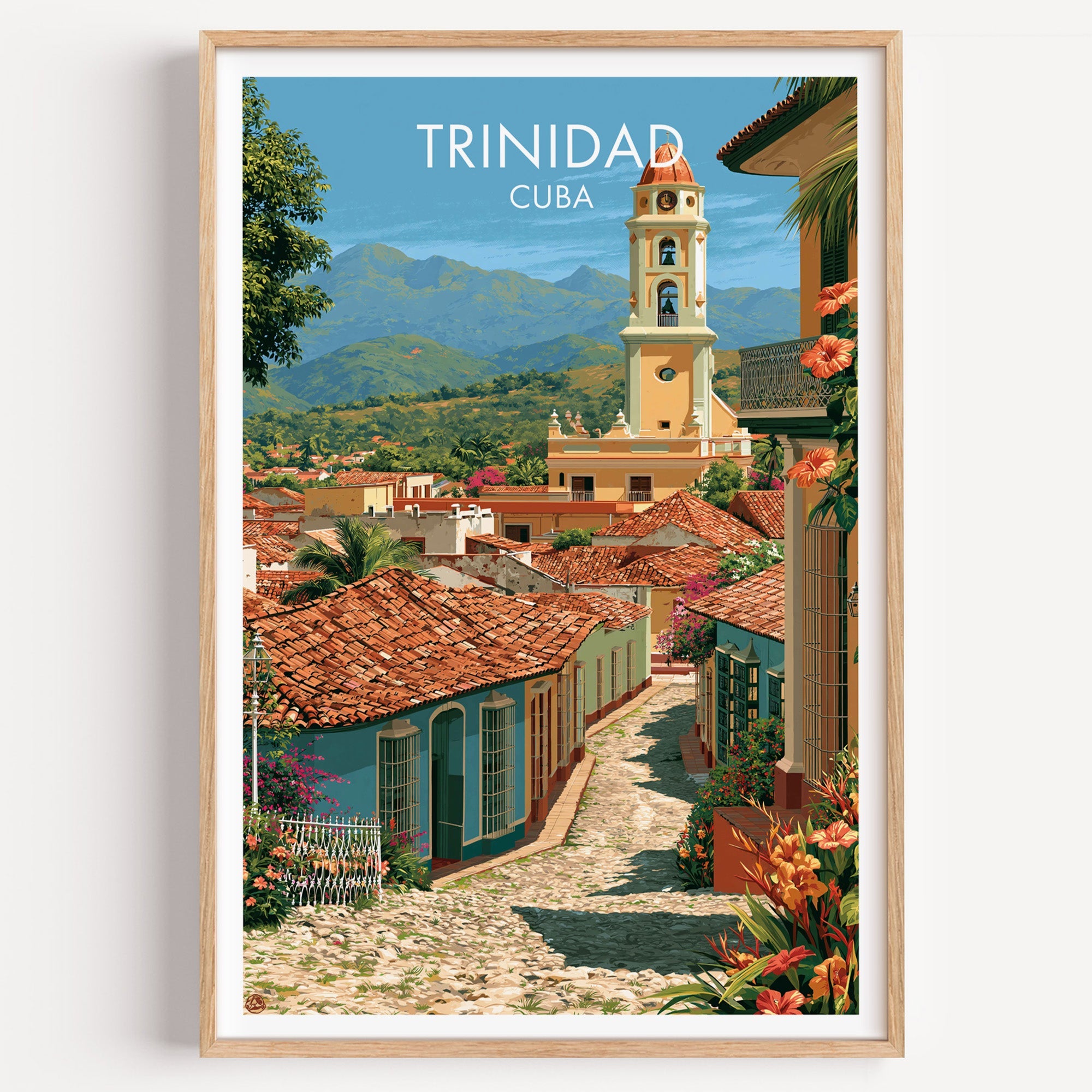 Trinidad Cuba print of a cobbled lane and tiled roofs in a light oak frame on a plain white wall