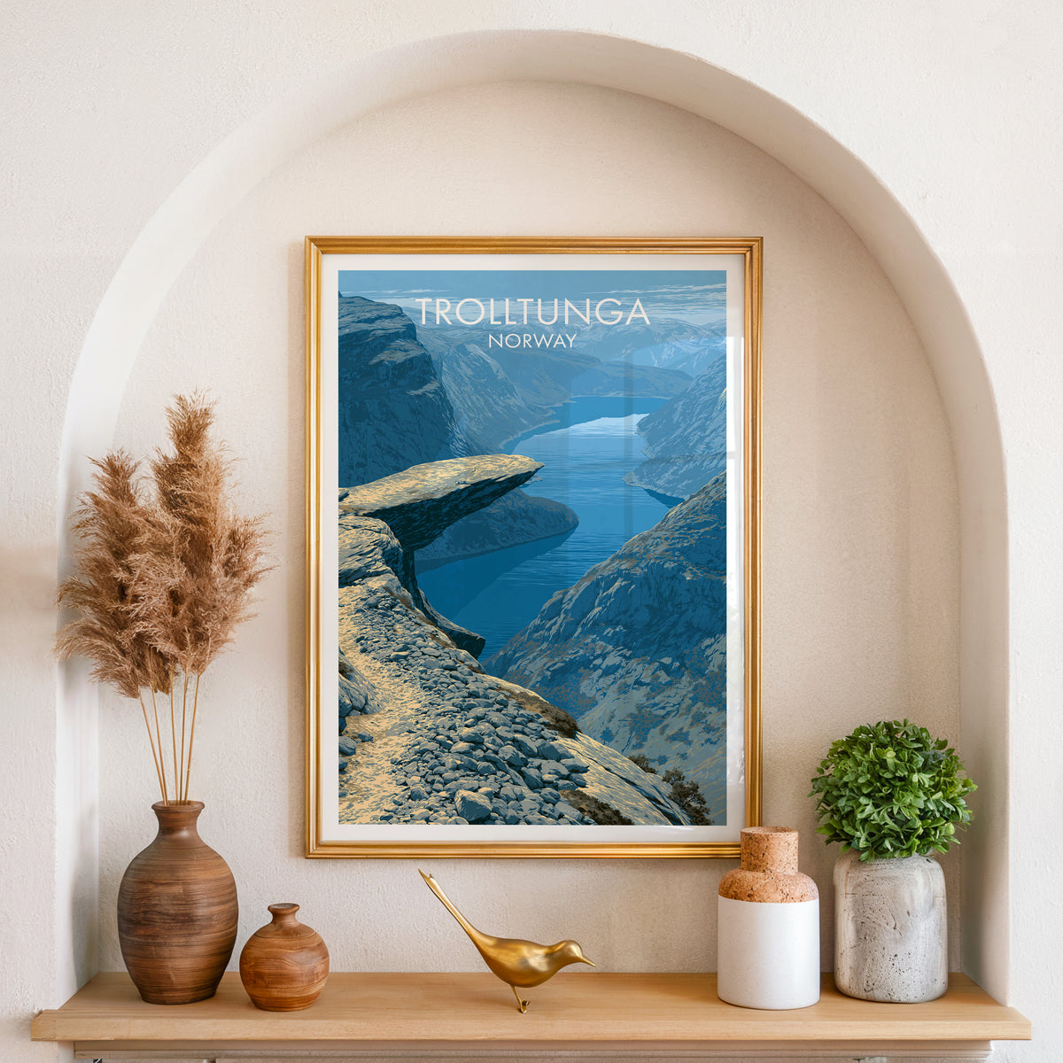 Trolltunga poster, gold frame in an arched wall niche above pampas grass in a clay vase