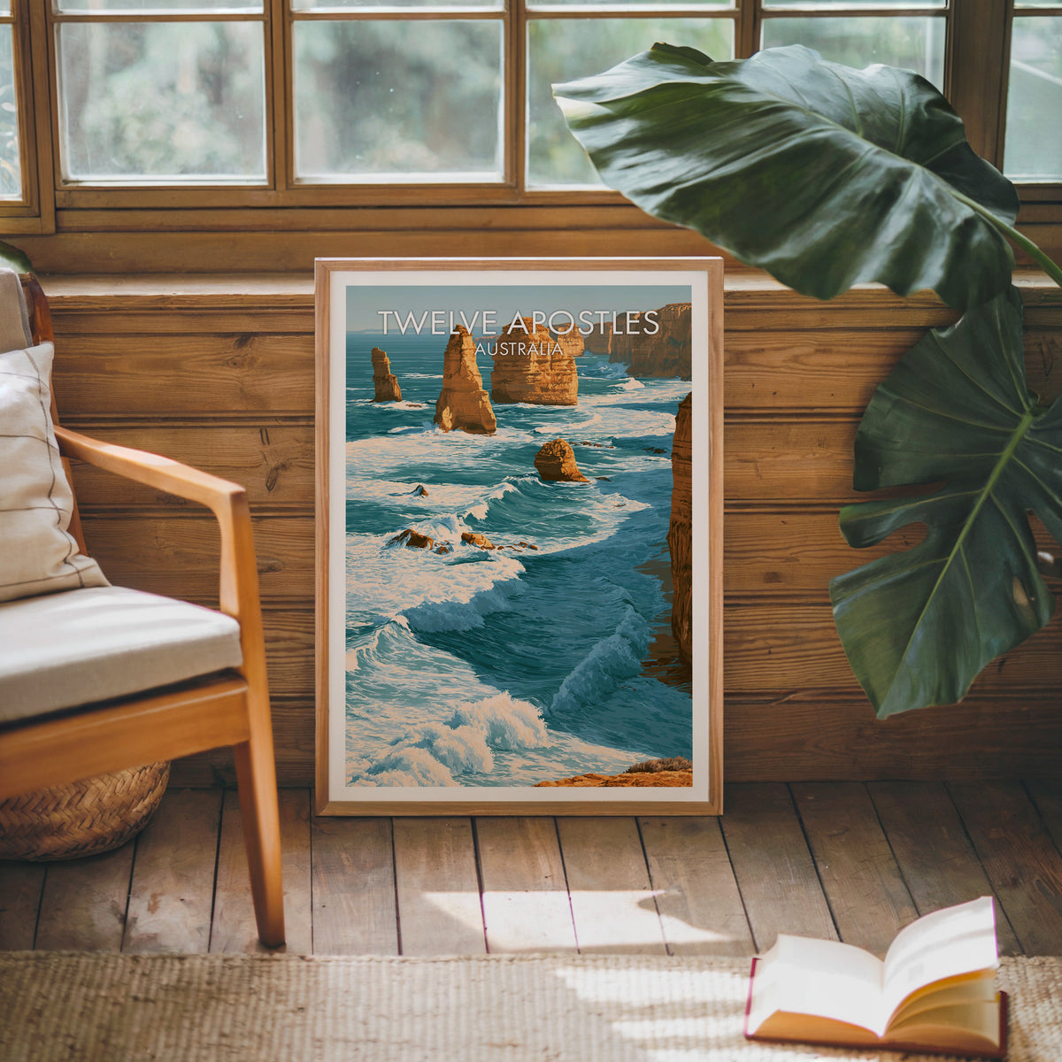 Ocean surf artwork in an oak frame leaning on a pine cabin wall beside a wooden armchair and jute rug
