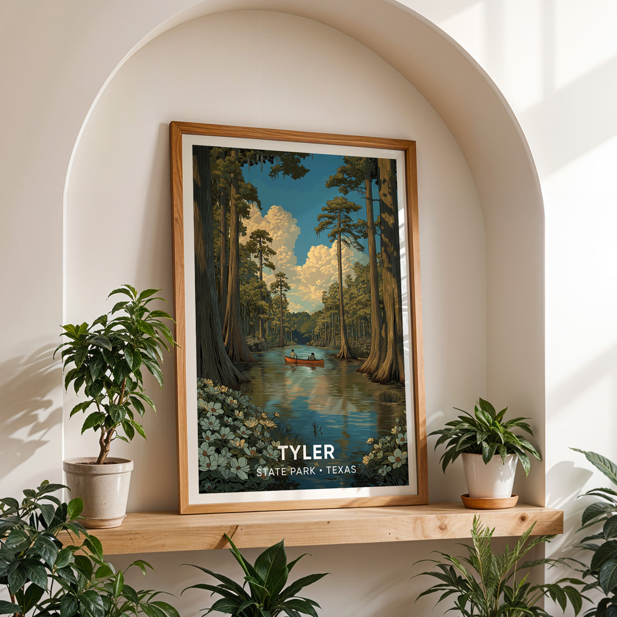 Tyler State Park canvas print in oak on a shelf in a white arched niche with potted plants each side.