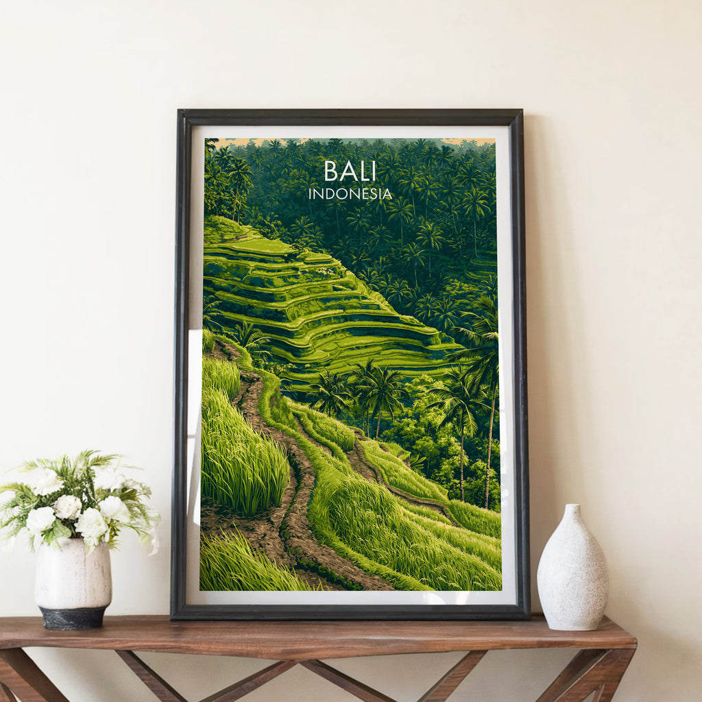 Ubud Rice Terraces Bali travel poster in a black frame on a wooden console table with white flowers
