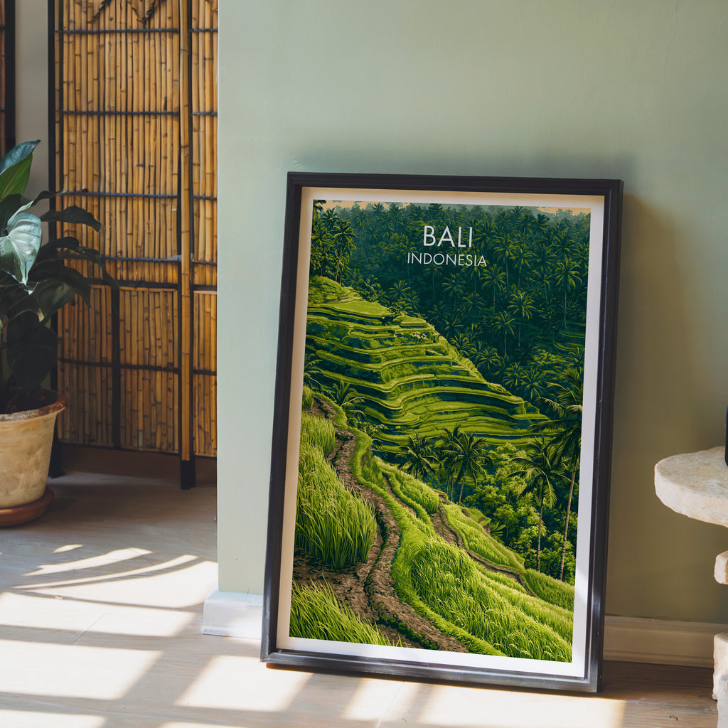 Ubud Rice Terraces Bali wall art in a black frame leaning against a sage green wall beside a bamboo screen