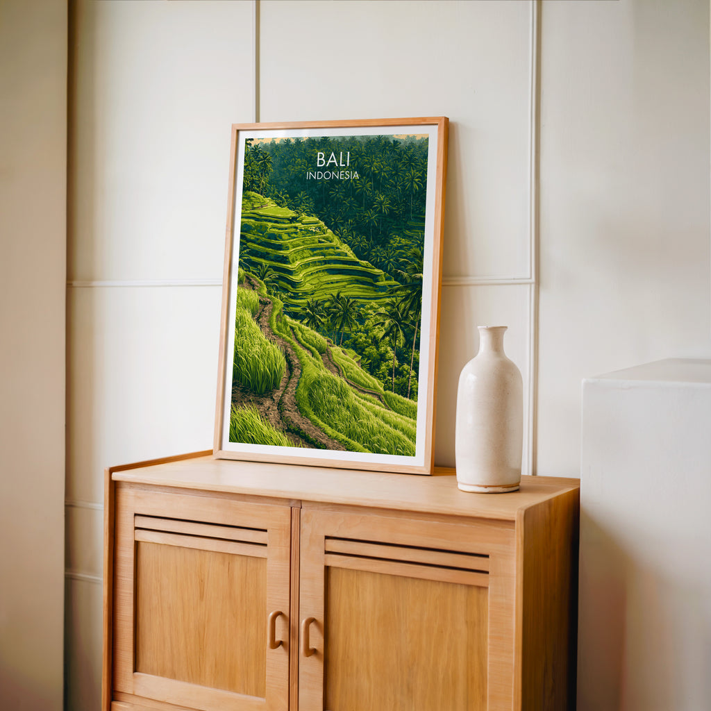 Small Ubud Rice Terraces Bali travel poster in an oak frame on a mid-century sideboard with a ceramic vase